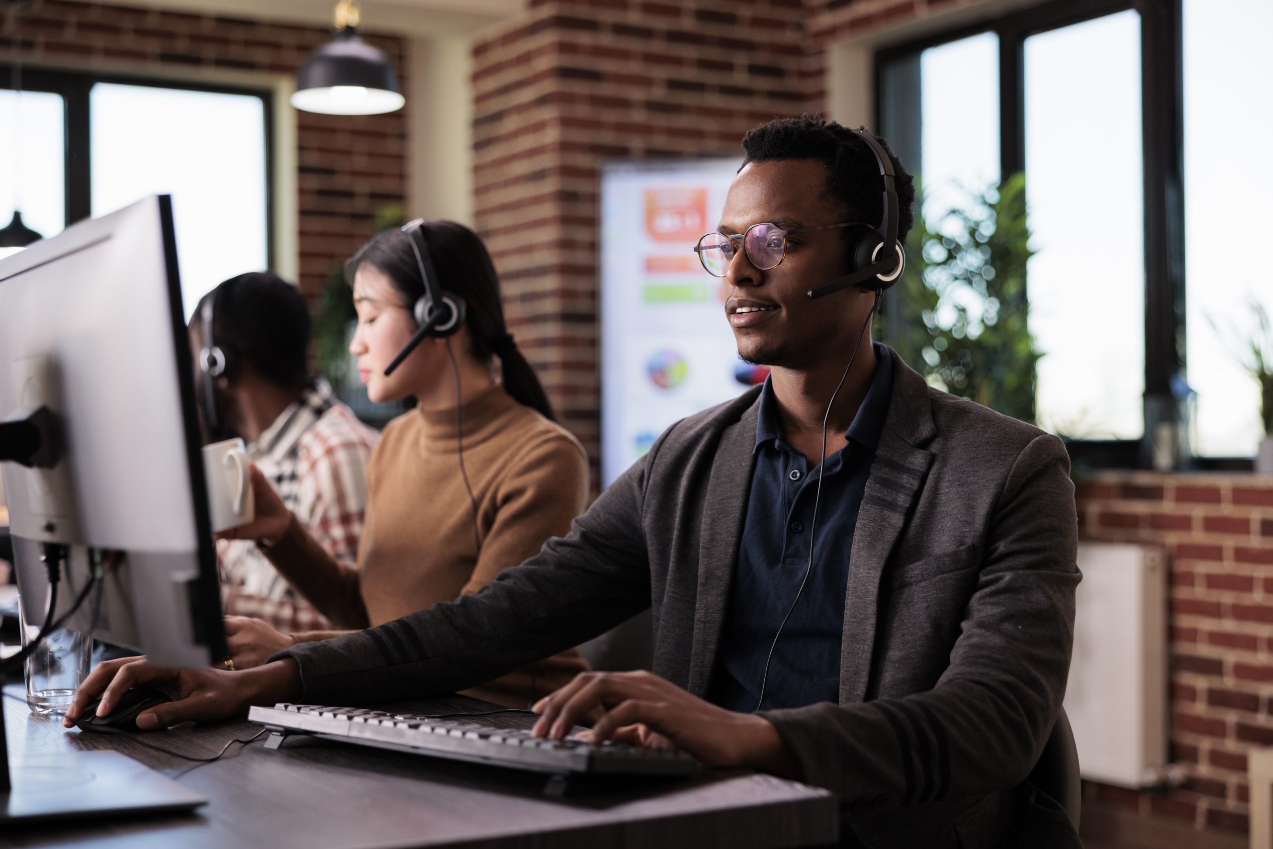 african american helpline employee working at call center